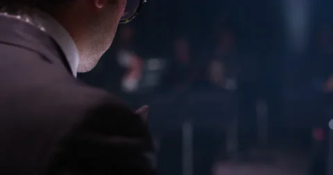 Close up of conductor directing symphony orchestra on classic theatre stage Stock Footage 154006835