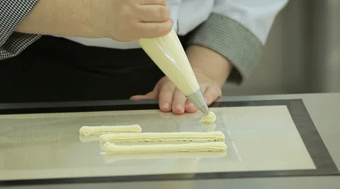 Close up of the confectioner-cook hands squeezes cream and makes parts for cake Stock Footage 50475479
