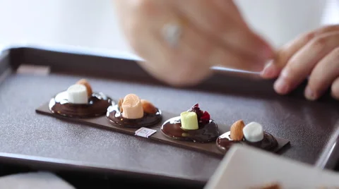 Close up of the confectioner-cook hands squeezes melted chocolate Stock Footage 58313160