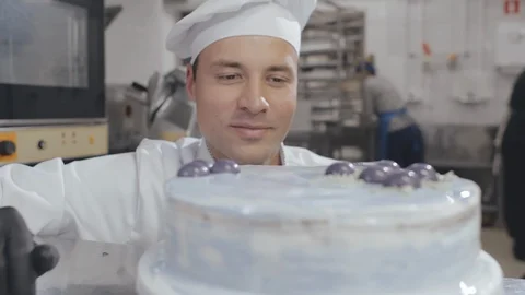 Close up of confectioner or pastry chef finishing cake Stock Footage