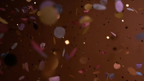 Close up of Confetti and Glitter Falling Against a Brown Backdrop Stock Footage 270403456