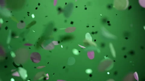 Close up of Confetti and Glitter Falling Against a Green Backdrop Stock Footage 270410076