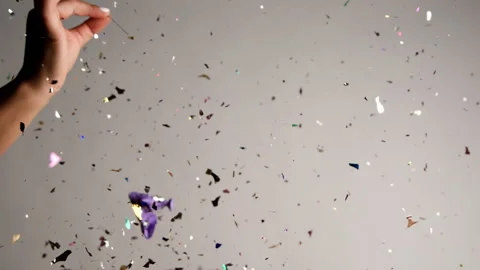Close up of Confetti and Glitter Falling Against a Green Backdrop Stock Footage 270410134