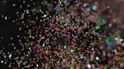 Close up Confetti explosion on black background. Slow Motion confetti falling Stock Footage 151950324