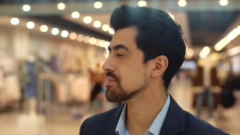 Close-up of confident bearded young man in suit turning head, looking at the Stock Footage 164930675