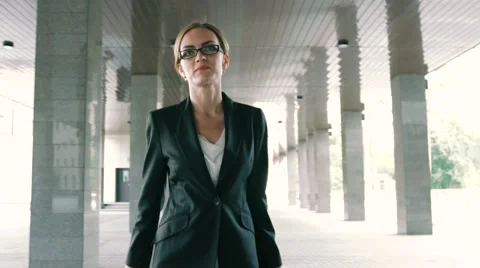 Close-up of a confident blond businesswoman walking with trolley Stock Footage