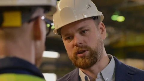 Close up of confident businessman talking to engineer Stock Footage 106571802