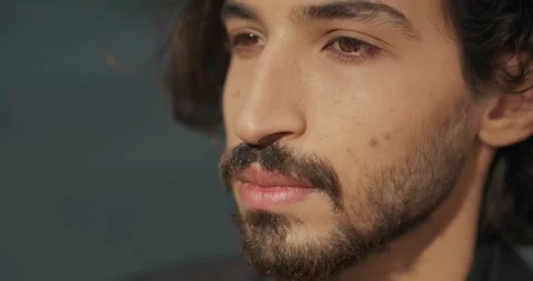 Close up of a confident millennial seriously looking forward. Video stock 245149339