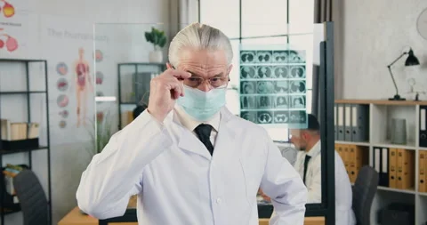 Close up of confident respected skilled mature grey-haired male doctor in facial Stock Footage 160418352