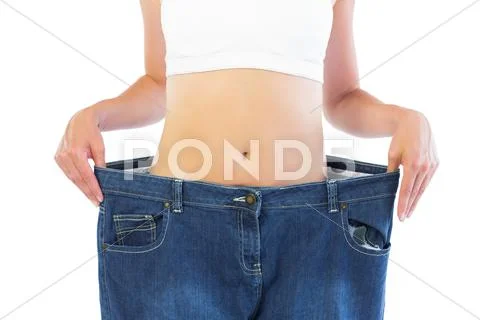 Close up of confident thin blonde wearing too big trousers Stock Photos