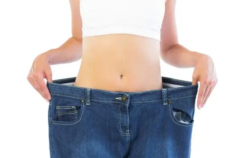 Close up of confident thin blonde wearing too big trousers Stock Photos