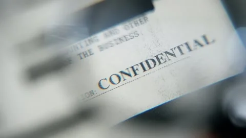 Close up on confidential text label on top secret government agency document Stock Footage 304281623