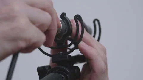 Close-up on connecting XLR cable into microphone on boompole Stock Footage 340417540