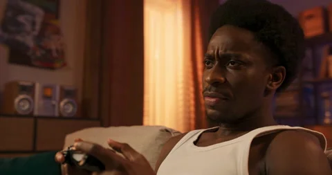 Close-up of a console pad used by a man while playing games on a TV set, a round 库存影片 200807148