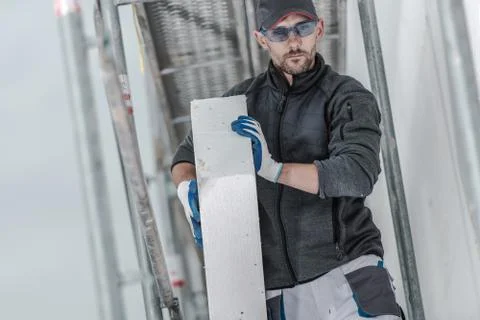 Close Up Of Construction Contractor On Scaffolding With Insulation Material F Stock Photos