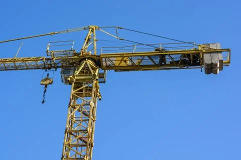 Close up construction crane builds new building Stock Photos