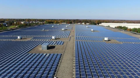Close Up of Construction Man Walking on the Rooftop of a Large Warehouse 120143411
