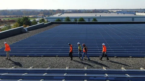 Close Up of Construction Men Walking and Waving Hi on The Rooftop 120143402