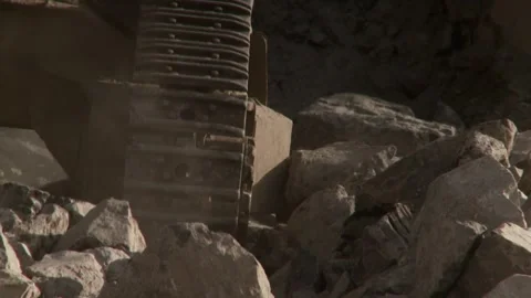 Close-up of construction vehicle moving over rocks Stock Footage 312400433