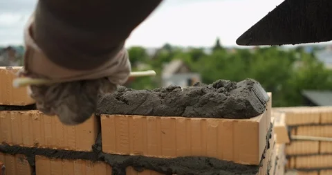 Close-up of construction work, bricklayer puts another brick in masonry of wall Stock Footage 117090920