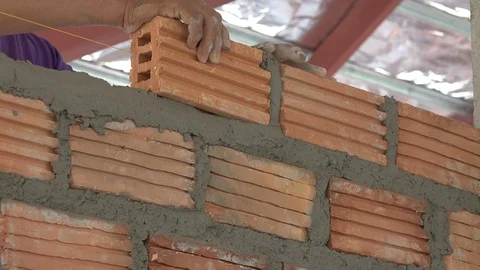 Close-Up Of Construction Work, Bricklayer Puts Another Brick In Masonry Of Wall Stock Footage 125594366