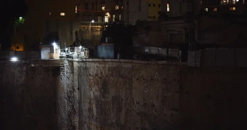 Close up of a construction worker at a building working site at night. BMPCC 4K Stock Footage 125847758