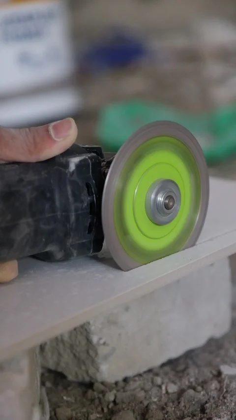 Close-Up of Construction Worker Cutting Ceramic Tile with Angle Grinder Tool Stock-Footage 342883087