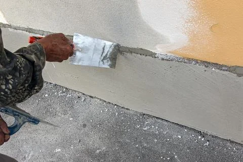 Close-Up Construction Worker Hand Smoothing Wall Putty Stock Photos