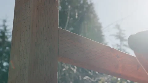 Close Up on Construction Worker installing Backer Rails to Fence Posts With.. Stock Footage 235573077