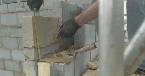 Close up of construction worker laying mortar between bricks jointing Stock Footage 246379029