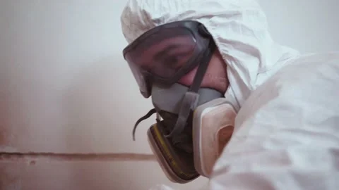 Close-up of a construction worker in protective mask makes a repair at new home Stockbeeldmateriaal 154326747