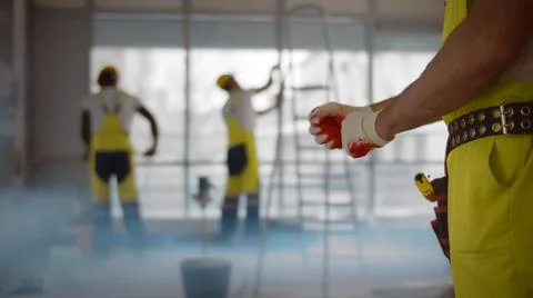 Close up of construction worker putting on gloves working in office Stock Photos