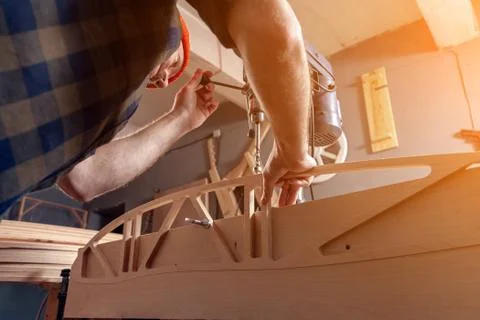 Close up of a Construction Worker Using Drill To wood. Drill machine on the t Stock Photos