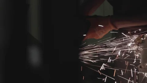 Close up of construction worker using grinder in the dark Stock Footage 69767399