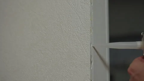 Close-up of construction worker using silicone gun to apply sealant, performing Stock Footage 306269795