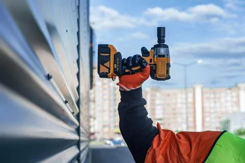 Close-up construction worker wearing high visibility safety vest and protecti Stock Photos