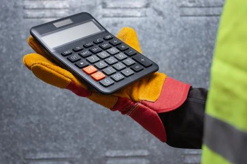 Close-up of a construction worker wearing protective gloves and safety vest.. Foto stock