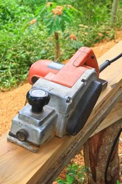 Close up construction worker's hand and power tool while planing Fotos Stock