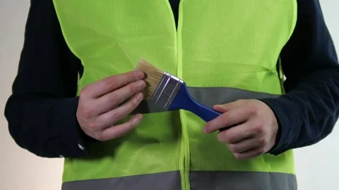 Close-up of a construction workers hand in a high-visibility vest thoughtfully Stock Footage 316584859
