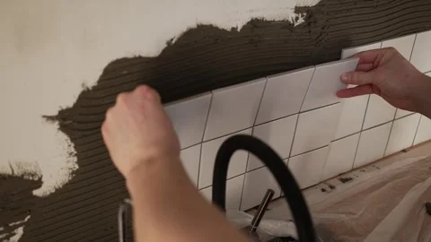 Close up of construction worker's hands carefully installing white ceramic Stock Footage 344568908