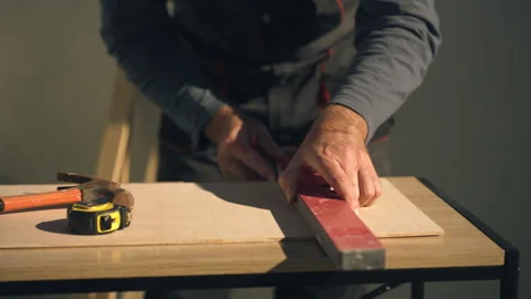 Close-up of construction workers hands in uniform using a spirit level on w.. Stock Footage 336025141