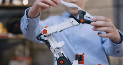 Close up of the constructor toy in hands of the little Caucasian boy in the blue Stock Footage 135842017