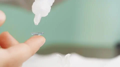 Close-up. on contact lens on a child's finger drip eye drops. Stock Footage