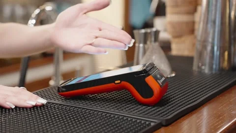 Close up of contactless card payment process with POS terminal in restaurant Stock Footage 327389550