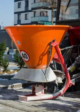Close-up of container  for spilling salt.  Standing  snow cleaning machine  c Stock Photos