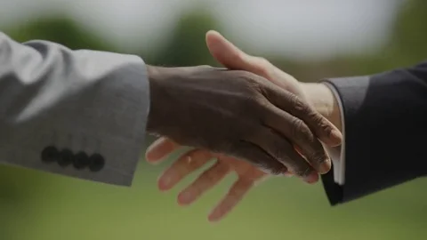 Close up of contract being signed with a handshake after, in slow motion Vidéo 77100976