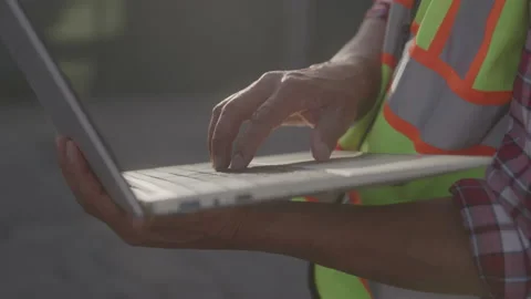 Close up of Contractor Typing on Computer at Construction Site on Sunny Day Stock Footage 208782765
