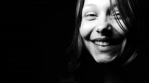 Close up contrasty black and white portrait of a young teen girl smiling at the Видео 62895204