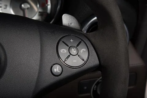 Close up of control buttons on black steering wheel Stock Photos