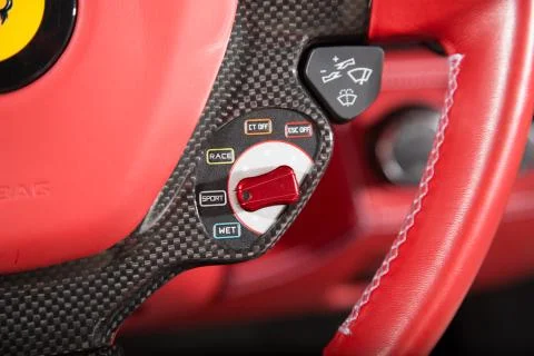 Close up of control buttons on red leather steering wheel Stock Photos